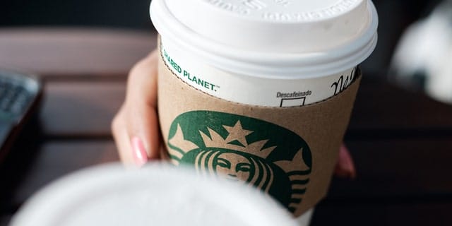 La Libertad, El Salvador - April 30, 2012: A single-use coffee cup bearing the Starbucks franchise logo.