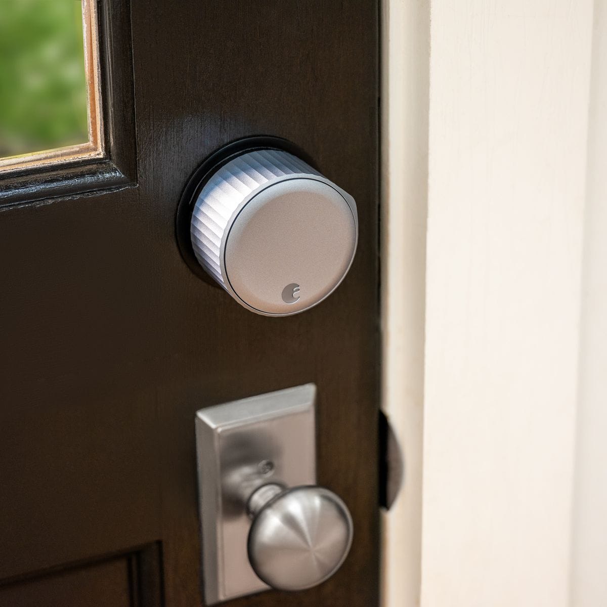 August Wi-Fi smart lock installed on brown door