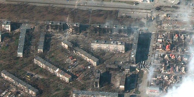 This satellite image provided by Maxar Technologies on Friday, March 18, 2022, shows damaged and burnt-out apartment buildings in Mariupol, Ukraine.